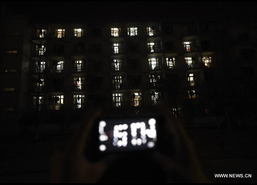 Lights in a dormitory building of the Anhui University form the shape of '60+' during the annual Earth Hour campaign in Hefei, capital of east China's Anhui Province, March 28, 2015. (Xinhua/Zhang Duan) 