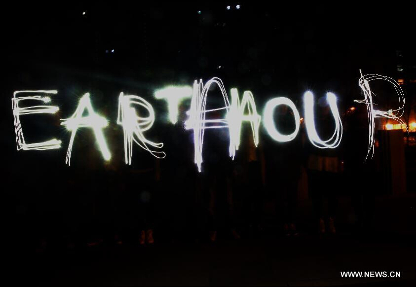 People in a community write the words of 'EARTH HOUR' with light during the annual Earth Hour campaign in Qinhuangdao, north China's Hebei Province, March 28, 2015. (Xinhua/Yang Shirao) (zwx)