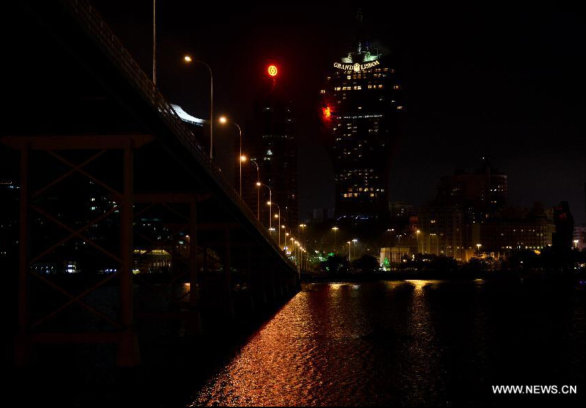 Lights are turned off in the Bank of China Macao branch and the surrounding areas during the annual Earth Hour campaign in Macao, south China, March 28, 2015. (Xinhua/Zhang Jinjia) 