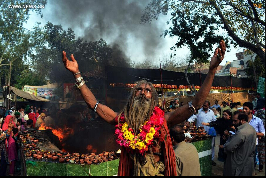 A devotee dances at the shrine of Muslim Sufi saint Shah Hussain, popularly known as Madho Lal Hussain, in eastern Pakistan's Lahore on March 28, 2015. Hundreds of devotees attended the 426th annual festival celebrations known as 'Mela Chiraghan' of Madhu Lal Hussain to pay homage to the 16th century saint. (Xinhua/Jamil Ahmed) 