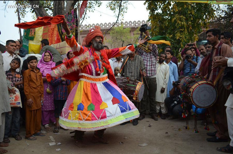 A devotee dances at the shrine of Muslim Sufi saint Shah Hussain, popularly known as Madho Lal Hussain, in eastern Pakistan's Lahore on March 28, 2015. Hundreds of devotees attended the 426th annual festival celebrations known as 'Mela Chiraghan' of Madhu Lal Hussain to pay homage to the 16th century saint. (Xinhua/Jamil Ahmed) 