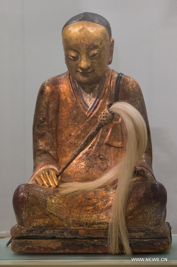 A Chinese Buddha statue with the mummified body of a Buddhist monk inside is on display at the Hungarian Natural History Museum in Budapest, Hungary on March 3, 2015. According to the Chinese characters written on the pilow of the statue, the body inside the statue belonged to Chinese Buddhist monk Zhang Liuquan who lived around A.D. 1100. [Photo/Xinhua]