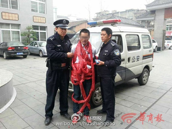 The man wrapped with firecrackers being arrested by police officers. [Photo/Huashang Daily]