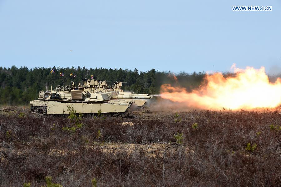 Tanks of U.S. troops stationed in Lithuania are seen during tank live-fire drills in Pabrade, Lithuania, on April 9, 2015. U.S. troops stationed in Lithuania held the first tank live-fire drills from April 8 to 9. [Photo/Xinhua] 