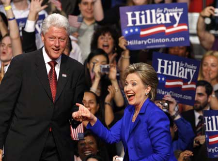 Former President Bill Clinton helps his wife and US Democratic presidential candidate Senator Hillary Clinton to the stage at her South Dakota and Montana presidential primary election night rally in New York June 3, 2008. [Photo/Xinhua]