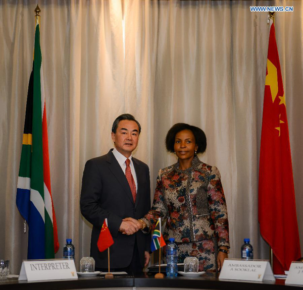 Visiting Chinese Foreign Minister Wang Yi (L) shakes hands with Maite Nkoana-Mashabane, Minister of the Department of International Relations and Cooperation of South Africa during their meeting in Pretoria, South Africa, on April 14, 2015. [Photo/Xinhua]