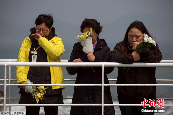 At the eve of the one year anniversary of the South Korean ferry Sewol disaster, family members of the victims gathered at a port of Jindo to commemorate their dearest ones on Wednesday. On April 16, 2014, South Korean ferry Sewol carrying 476 people capsized and sank off the country's southwestern coast, leaving 295 dead, including four Chinese nationals, and nine missing. [Photo/Chinanews.com]