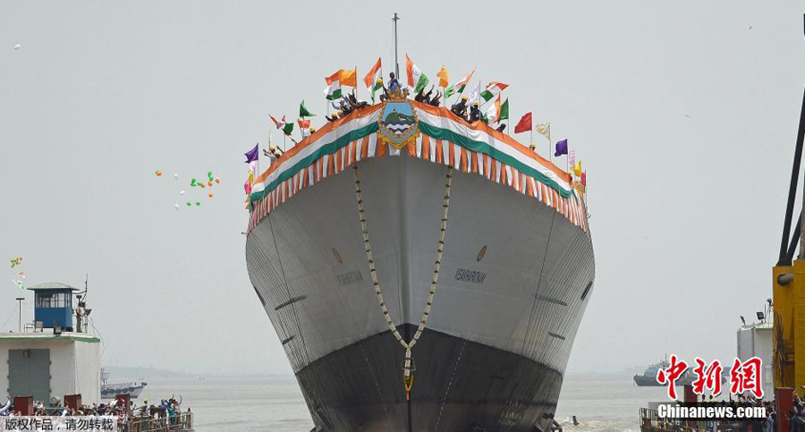India's new naval stealth destroyer Visakhapatnam sails into the Arabian Sea during its launch at Mazagon Dock in Mumbai, India, April 20, 2015. The new warship, Visakhapatnam, is named after a port city in the southern Indian state of Andhra Pradesh and it will be able to operate in nuclear, biological and chemical atmosphere, sources said. [Photo/Chinanews.com]