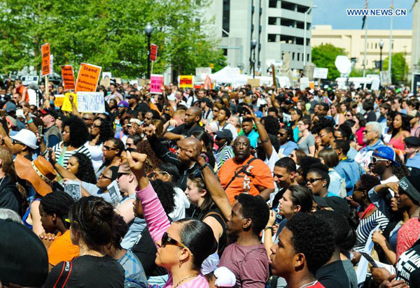 People attend a rally in front of the City Hall in Baltimore, Maryland, the United States, May 2, 2015. 