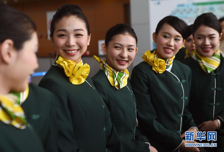 A group of flight attendants from Taiwan prepare for their first flight service on Shanghai's budget carrier Spring Airlines on May 7, 2015. [Photo: Xinhua] 