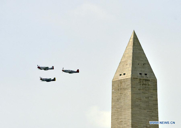 World War II vintage aircraft fly near the Washington Monument in Washington D.C., capital of the United States, May 8, 2015. Diverse arrays of U.S. World War II aircraft flew over the capital Washington D.C. Friday, commemorating the 70th anniversary of World War II victory in Europe. (Xinhua/Yin Bogu)