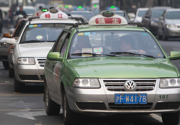 Taxis on the road in Shanghai. The city will legalize car-hailing smartphone applications via an official public services function. [Xinhua]