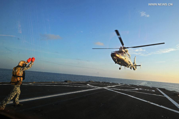 A Dolphin Z-9 helicopter of China's Navy missile frigate CNS Yulin flies off the deck of Singapore's Navy missile frigate RSS Intrepid during the 'Exercise Maritime Cooperation 2015', May 25, 2015. The Singapore and Chinese navies on Monday concluded the inaugural Exercise Maritime Cooperation 2015. Chinese missile frigate Yulin, Singapore's Formidable-class frigate (RSS Intrepid) and Victory-class missile corvette (RSS Valiant) participated in the bilateral maritime exercise. [Photo/Xinhua]