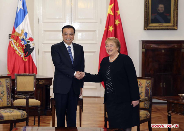 Chinese Premier Li Keqiang (L) shakes hands with Chilean President Michelle Bachelet during their talks in Santiago, Chile, May 25, 2015. China and Chile on Monday signed a host of cooperation deals including a multi-billion-U.S.-dollar currency swap pact as the two countries move to enhance their trade and financial ties. [Photo/Xinhua]