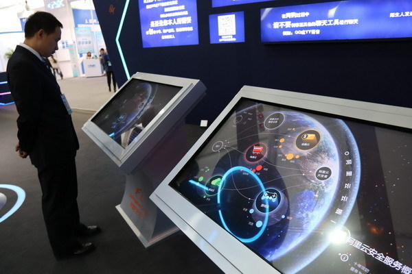 A man looks at Aliyun cyber security services, platform provided by Alibaba, which is shown at a cyber security exhibition on Nov 24, 2014. [Photo by Wang Yueling / Asianewsphoto]