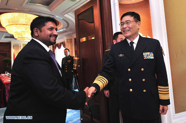 Admiral Sun Jianguo (R), vice chief of staff of China's People's Liberation Army (PLA), meets with Ruwan Wijewardene, Sri Lanka's State Minister of Defense, on the sidelines of the 14th Shangri-La Dialogue in Singapore, on May 29, 2015. (Xinhua/Then Chih Wey) 