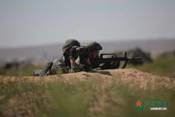 Two soldiers are on the alert during the drill.