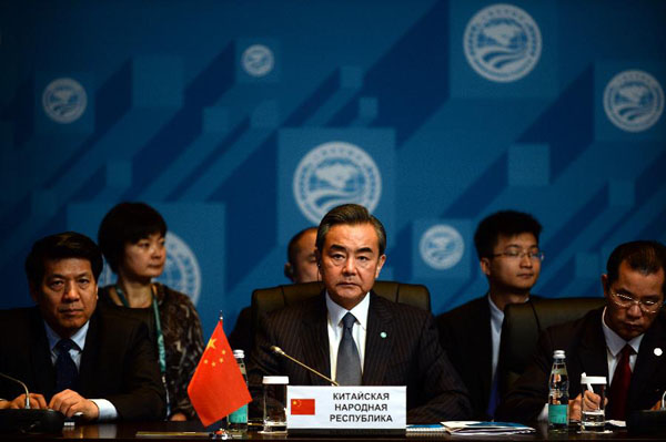 Chinese Foreign Minister Wang Yi (C) attends a Shanghai Cooperation Organization (SCO) meeting on regional security and stability in Moscow, Russia, June 4, 2015. [Photo/Xinhua]