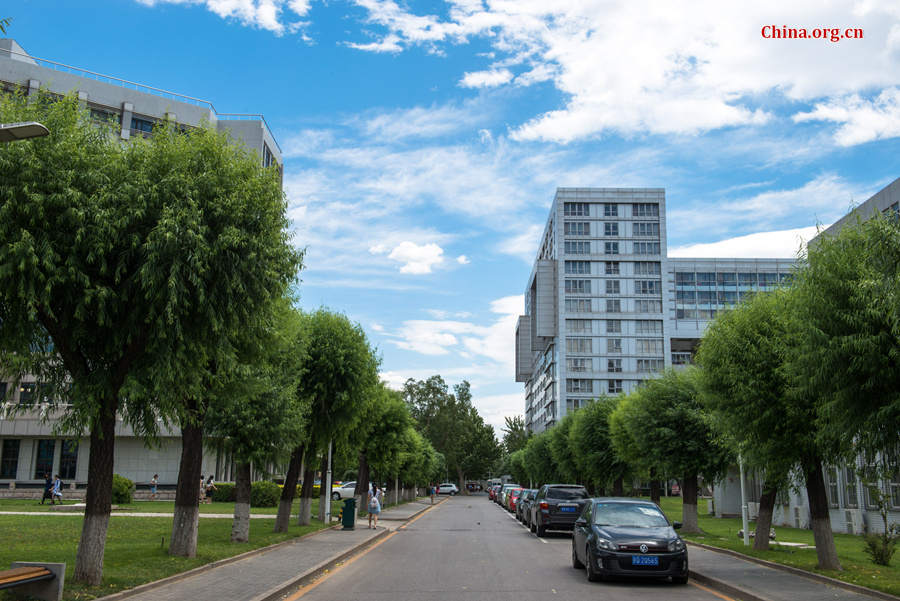 The sky above Capital Normal University in downtown Beijing is a crystal-clear blue on Thursday, June 11, 2015, after days of thunderstorms. Sunshine piercing through the white clouds brings a summery look to everything in the city below. [Photo by Chen Boyuan / China.org.cn]