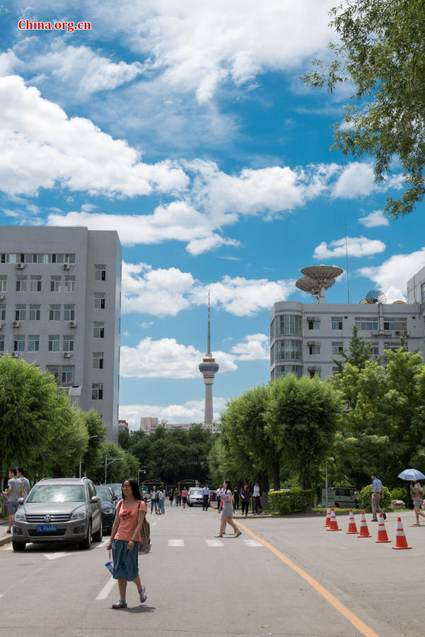 The sky above Capital Normal University in downtown Beijing is a crystal-clear blue on Thursday, June 11, 2015, after days of thunderstorms. Sunshine piercing through the white clouds brings a summery look to everything in the city below. [Photo by Chen Boyuan / China.org.cn]