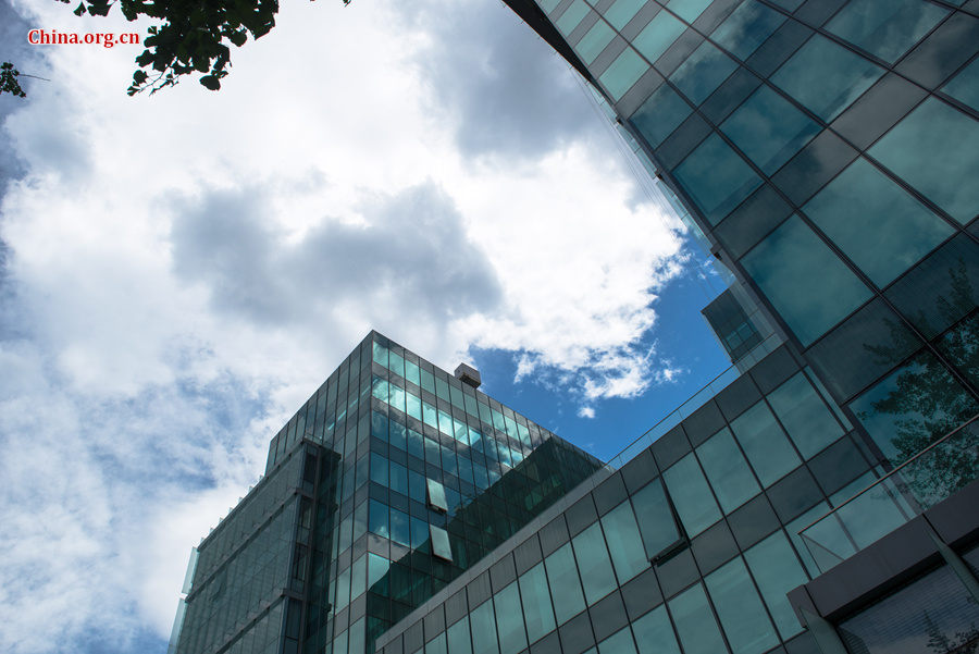 The sky above Capital Normal University in downtown Beijing is a crystal-clear blue on Thursday, June 11, 2015, after days of thunderstorms. Sunshine piercing through the white clouds brings a summery look to everything in the city below. [Photo by Chen Boyuan / China.org.cn]