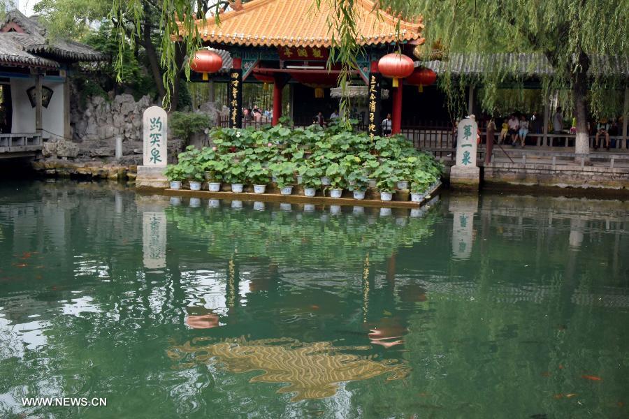 Tourists visit the Baotu Spring in Jinan, capital of east China's Shandong Province, June 22, 2015. The famous scenery spot Baotu Spring stopped spouting due to low underground water level during the Dragon Boat festival holiday. [Xinhua]