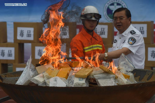 Police officers destroy drugs in Guiyang, capital of Southwest China's Guizhou province, June 23, 2015. The local police destroyed more than 1,200 kilograms of drugs on Tuesday, three days ahead of the International Day Against Drug Abuse and Illicit Trafficking. [Photo/Xinhua]