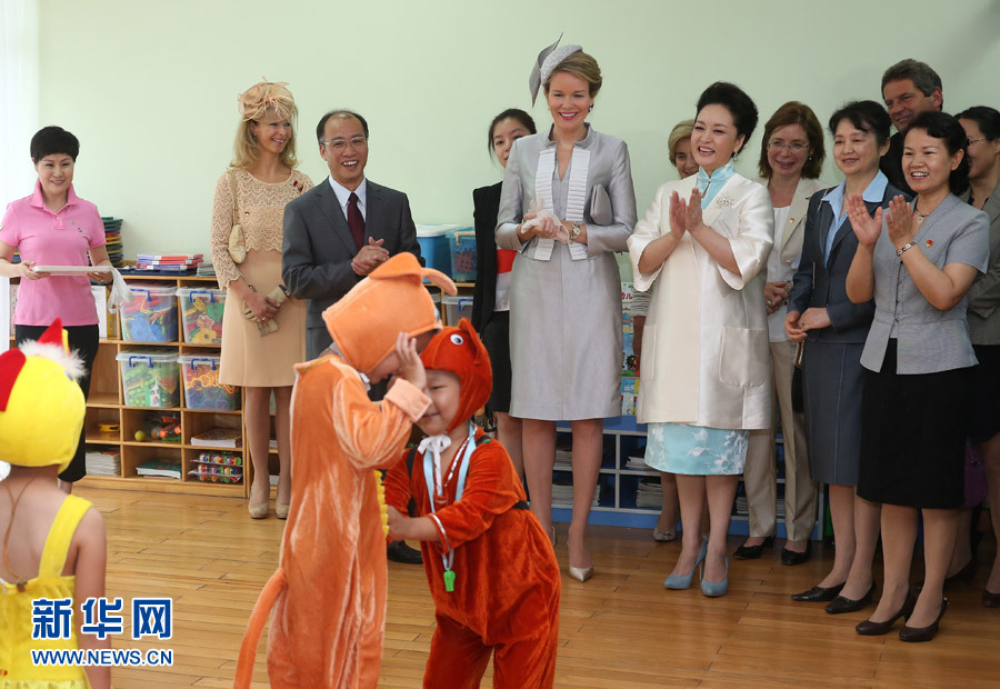 Chinese President Xi Jinping's wife Peng Liyuan and Queen Mathilde of Belgium watch children performing at the Beijing Experimental School for the Deaf in Beijing, capital of China, June 24, 2015. 