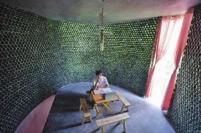 Li Rongjun enjoys the sunshine in his office, which was built with 8,500 beer bottles. 