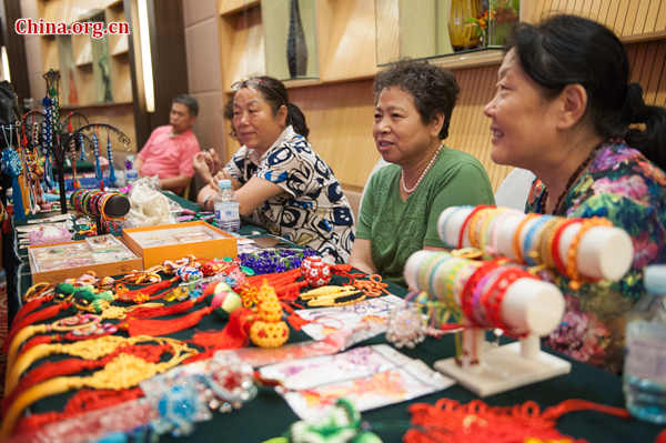 Women working at enterprises oriented to rural women in China showcase their products at the launch ceremony of @Her Entrepreneurship Plan in Beijing on Tuesday, June 30, 2015. [Photo by Chen Boyuan / China.org.cn]
