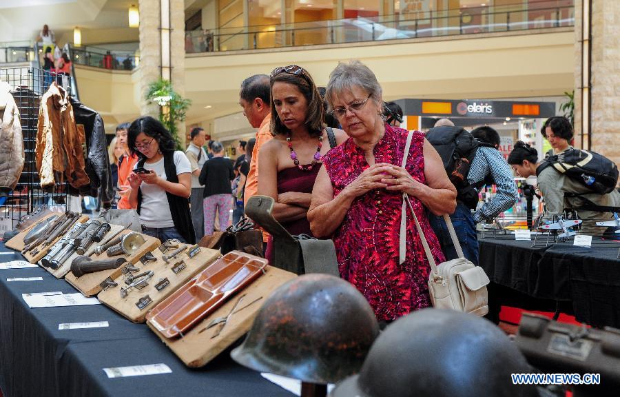 People visit the exhibition named 'Welcome Home, Flying Tigers' held at Puente Hill Mall in Los Angeles, the United States, on July 5, 2015. A cultural exhibition named 'Welcome Home, Flying Tigers' is held here in order to commemorate the 70th anniversary of Chinese people's Anti-Japanese War and the World Anti-Fascist War.[Photo/Xinhua]