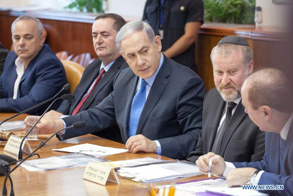 Israeli Prime Minister Benjamin Netanyahu (C) attends the weekly cabinet meeting at the Prime Minister's office in Jerusalem, on July 12, 2015. Israeli Prime Minister Benjamin Netanyahu slammed Sunday the international community for making concessions to the Iranians in the nuclear talks ahead of an upcoming deal, while Iranian leaders vowed to continue fighting the United States and Israel. [Photo/Xinhua]