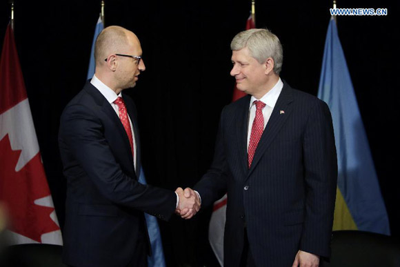 Canadian Prime Minister Stephen Harper (R) meets with Ukrainian Prime Minister Arseniy Yatsenyuk in Chelsea, Canada on July 14, 2015. Ukraine and Canada have successfully concluded negotiations over the Canada-Ukraine Free Trade Agreement (CUFTA), the Office of the Canadian Prime Minister announced. [Photo/Xinhua]