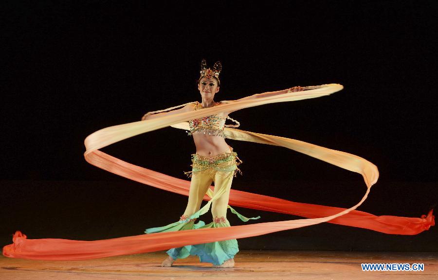 A dancer from Beijing Dance Academy performs during the 4th China Xinjiang International Folk Dancing Festival in Urumqi, northwest China's Xinjiang Uygur Autonomous Region, July 28, 2015. [Xinhua]