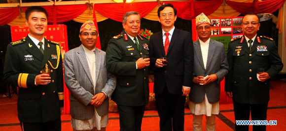 Chinese Ambassador to Nepal Wu Chuntai (3rd R) and Nepal's Army Chief Gaurav Shumsher Rana (3rd L) pose during a reception celebrating the 88th anniversary of the founding of the Chinese People's Liberation Army (PLA) in Kathmandu, Nepal, July 29, 2015. [Photo/Xinhua]