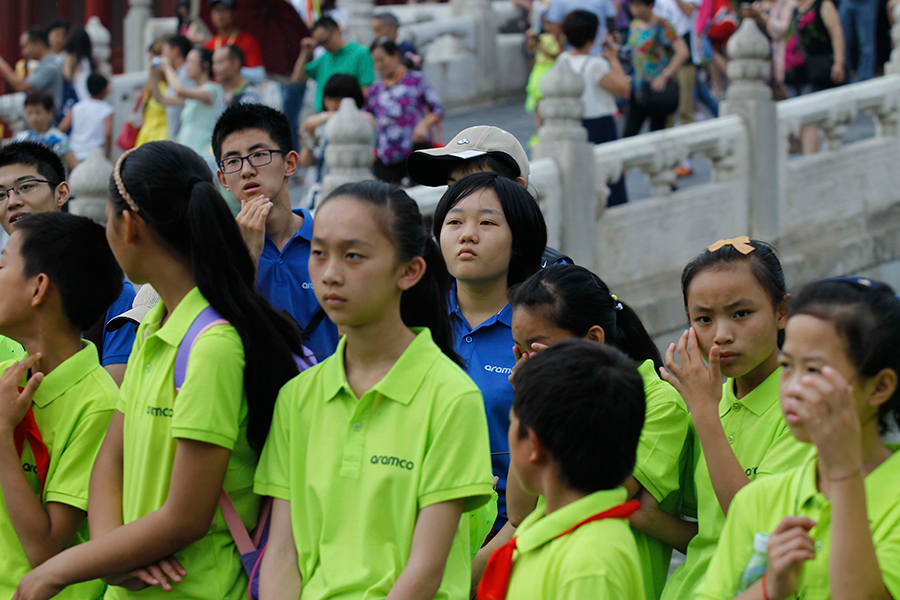 Students from Yunnan visit the Palace Museum in Beijing with program volunteers on July 30, 2015. [Photo by Zhu Xingxin/chinadaily.com.cn]