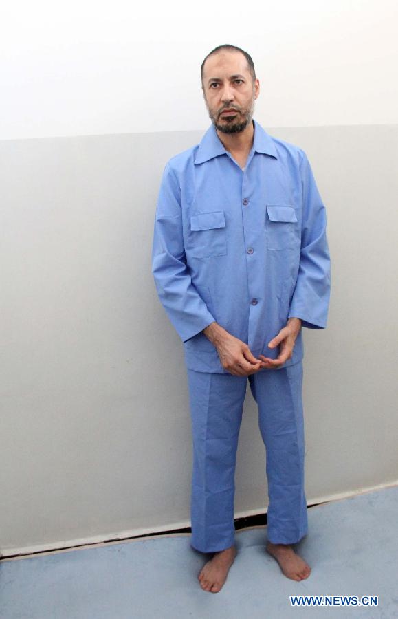 Saadi Gaddafi, son of Libya's former leader Muammar Gaddafi, stands in al-Hadba prison in Tripoli, Libya, Aug. 10, 2015. An amateur video posted on social media showed Saadi blindfolded while a group of people beat and insulted him. Libyan Attorney General last week issued a decision to investigate the video and identify the people shown torturing Saadi in the video. [Photo/Xinhua]