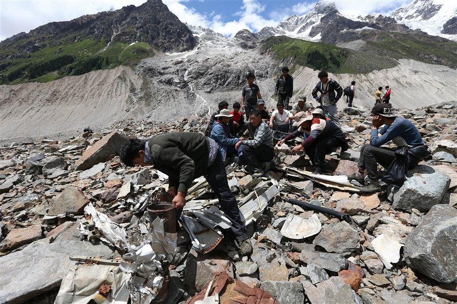 Volunteers collect wreckage of a C-87 US cargo plane which crashed in the Himalayas in 1944 while helping supply China during World War II. The plane, with five US crewmen on board, was on a Hump Route mission when it crashed. — Xinhua