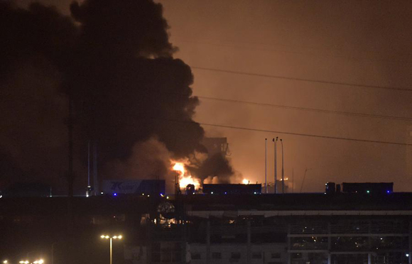 Smoke and fire are seen after an explosion in the Binhai New Area in north China's Tianjin Municipality on Aug. 13, 2015. An explosion rocked the Binhai New Area in north China's Tianjin Municipality at around 11:30 p.m. Wednesday. The cause and casualties are not immediately known. [Photo/Xinhua]