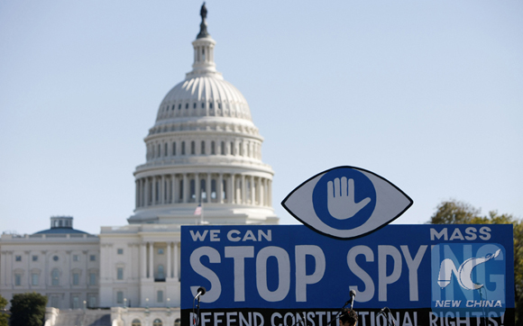 A huge slogan board stands in front of the U.S. Capitol building during a protest against government surveillance in Washington D.C., capital of the United Sates, on Oct. 26, 2013. Groundless accusations and 'microphone diplomacy' are not solving any problems, said spokesman of the Chinese embassy in Washington Zhu Haiquan on Monday.[Photo/Xinhua]