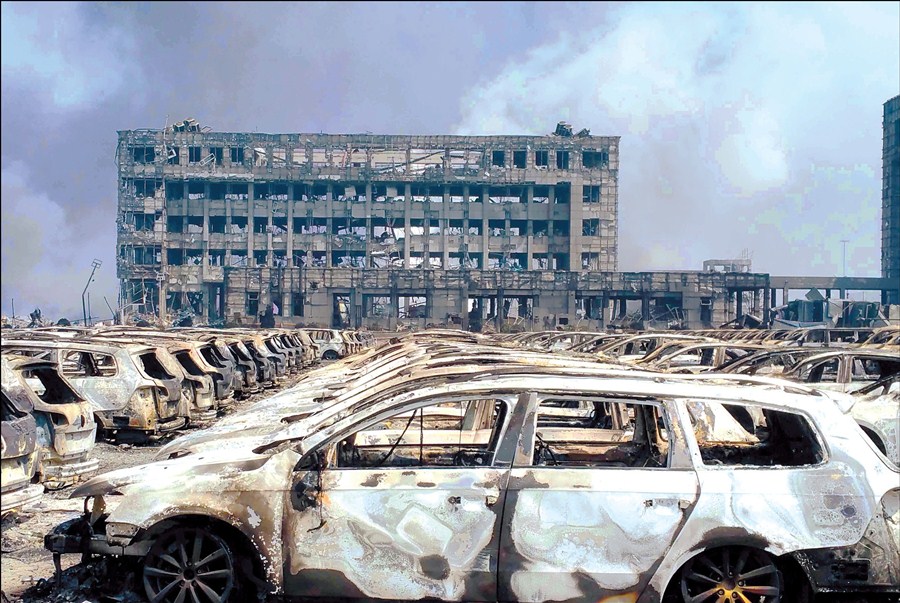 Burned-out cars lie in neat rows near the site of two huge explosions at the Binhai New Area in Tianjin. 