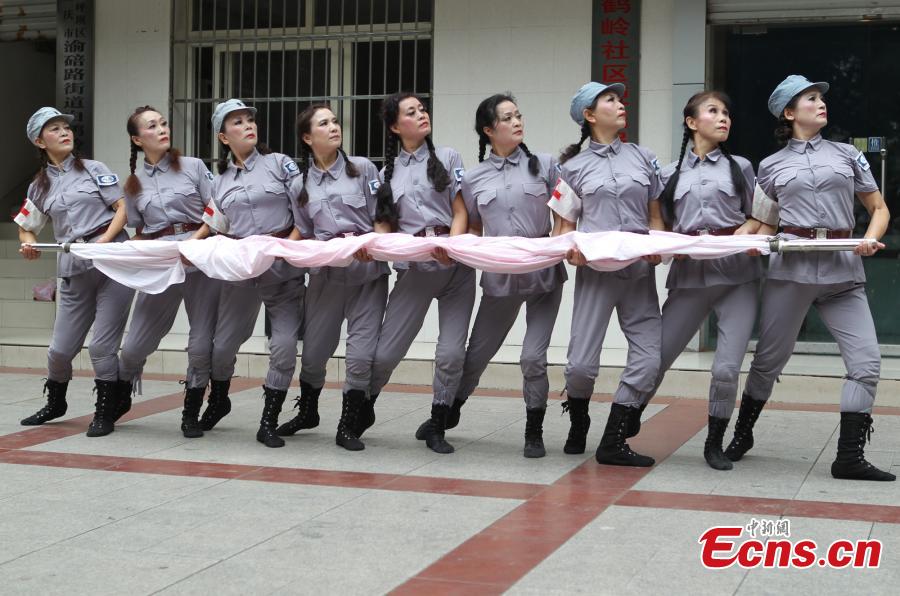 Members of an art troupe from Chongqing University for the Elderly perform to mark the 70th anniversary of victory in the Chinese People's War of Resistance Against Japanese Aggression (1937-1945) in Southwest China's Chongqing municipality, Aug 26, 2015. The average age of the 26 art troupe members is 60 years old and they choreographed the performance themselves. Some players lost family members during the Japanese aggression. [Photo/China News Service]