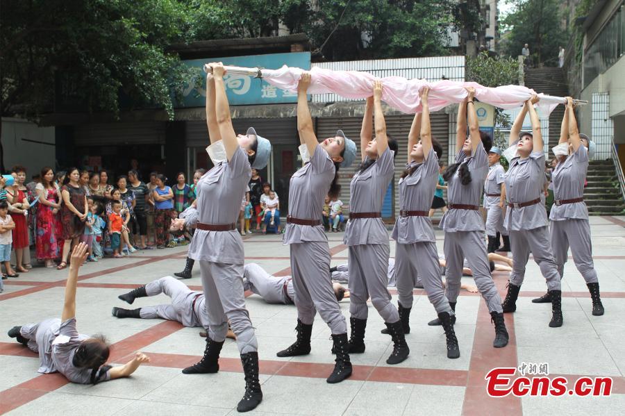 Members of an art troupe from Chongqing University for the Elderly perform to mark the 70th anniversary of victory in the Chinese People's War of Resistance Against Japanese Aggression (1937-1945) in Southwest China's Chongqing municipality, Aug 26, 2015. The average age of the 26 art troupe members is 60 years old and they choreographed the performance themselves. Some players lost family members during the Japanese aggression. [Photo/China News Service]