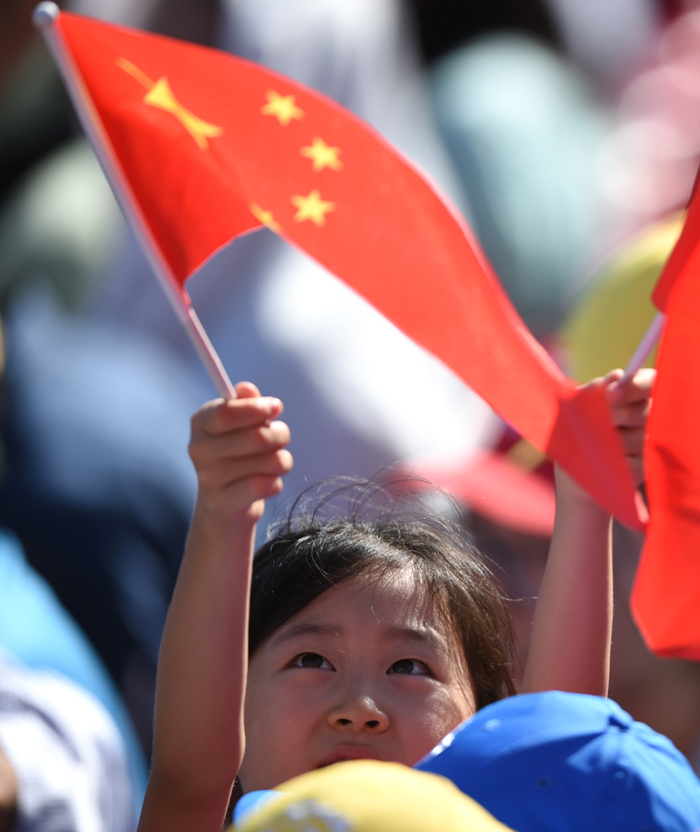 A little girl is seen among the audience watching the military parade on Sept. 3 on the Tian&apos;anmen Square in Beijing, capital of China. [Photo/Xinhua] 
