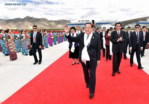 Yu Zhengsheng (front), chairman of the National Committee of the Chinese People's Political Consultative Conference (CPPCC), arrives in Lhasa, capital of Southwest China's Tibet autonomous region, Sept 6, 2015, leading a central government delegation to attend festivities marking the 50th anniversary of the region's founding.[Photo/Xinhua]