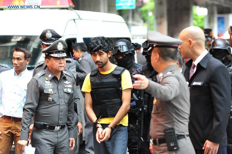 Yusufu Mieraili (C), one of the suspects in the Bangkok bombing, makes a crime re-enactment under escort of Thai police officers at a shopping center near Erawan Shrine in Bangkok, Thailand, Sept. 9, 2015. Yusufu Mieraili was arrested in Thailand's Sa Kaeo province near Cambodian border on Sept. 1. [Xinhua]