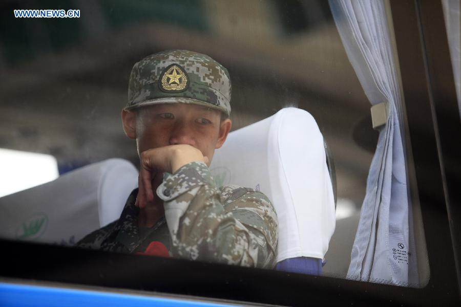 A new army recruit is on the verge of tears after a farewell ceremony in Liucheng County, south China's Guangxi Zhuang Autonomous Region, Sept. 10, 2015. The new recruits of the People's Liberation Army and paramilitary police force joined their units to fulfill their duty around the country recently. [Xinhua]