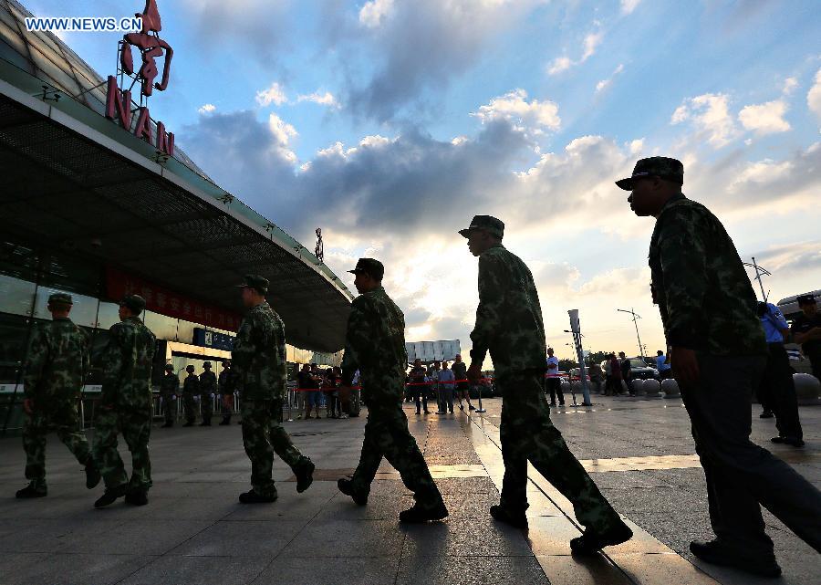 Army recruits walk into a train station after a farewell ceremony in Nantong, east China's Jiangsu Province, Sept. 10, 2015. The new recruits of the People's Liberation Army and paramilitary police force joined their units to fulfill their duty around the country recently. [Xinhua]