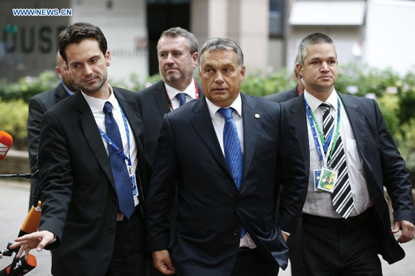 Hungary's Prime minister Viktor Orban (C) arrives to attend an European Union (EU) emergency summit on the migration crisis at EU Headquarters in Brussels, Belgium, Sept. 23, 2015. (Xinhua/Ye Pingfan)