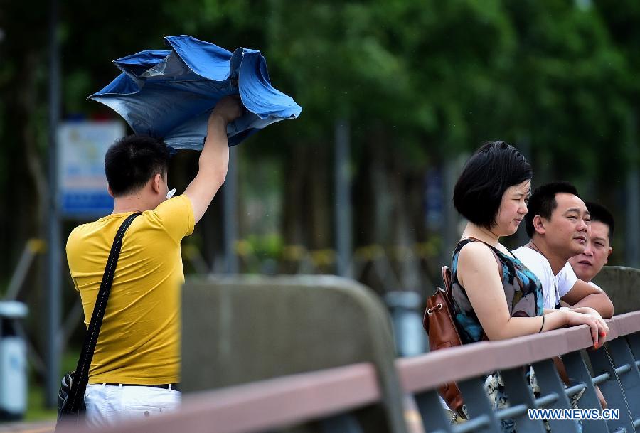 A man walks against wind in Shenzhen, south China's Guangdong Province, Oct. 4, 2015. Typhoon Mujigae, the 22nd typhoon this year, landed on South China's Guangdong Province on Sunday. [Photo/Xinhua]